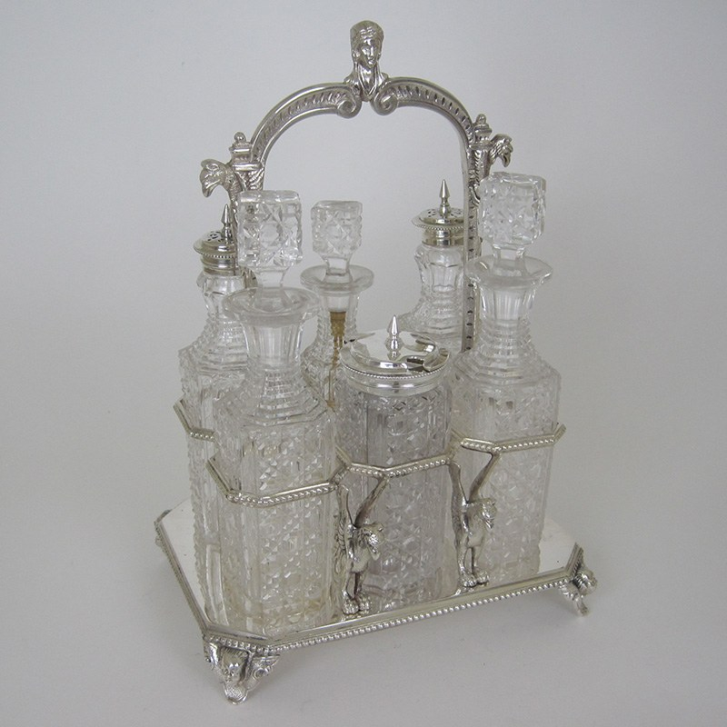 6 Bottle Victorian Silver Plated Cruet Set with Loop Cast Figural Motif Handle