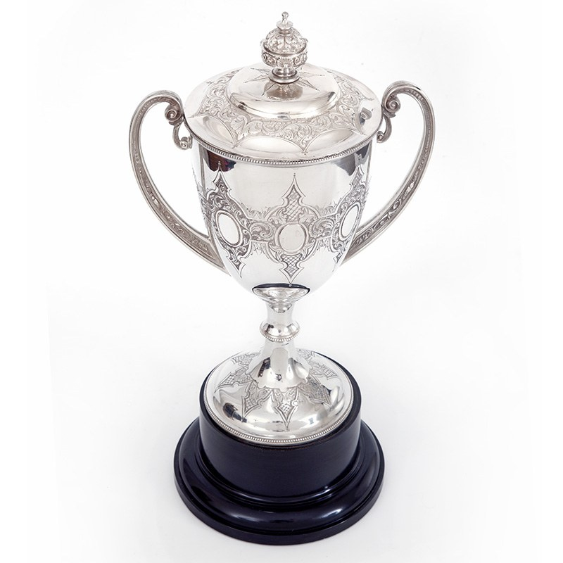 Antique Silver Plated Trophy with Two Cast Scroll Handles Standing on a Black Plinth