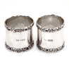Pair of Boxed Edwardian Silver Napkin Rings with Plain Bodies and Floral and Scroll Borders